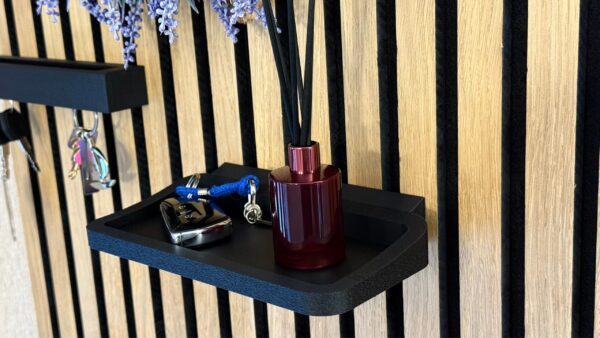 Matte black wall shelf on acoustic panel – modern minimalist interior decor